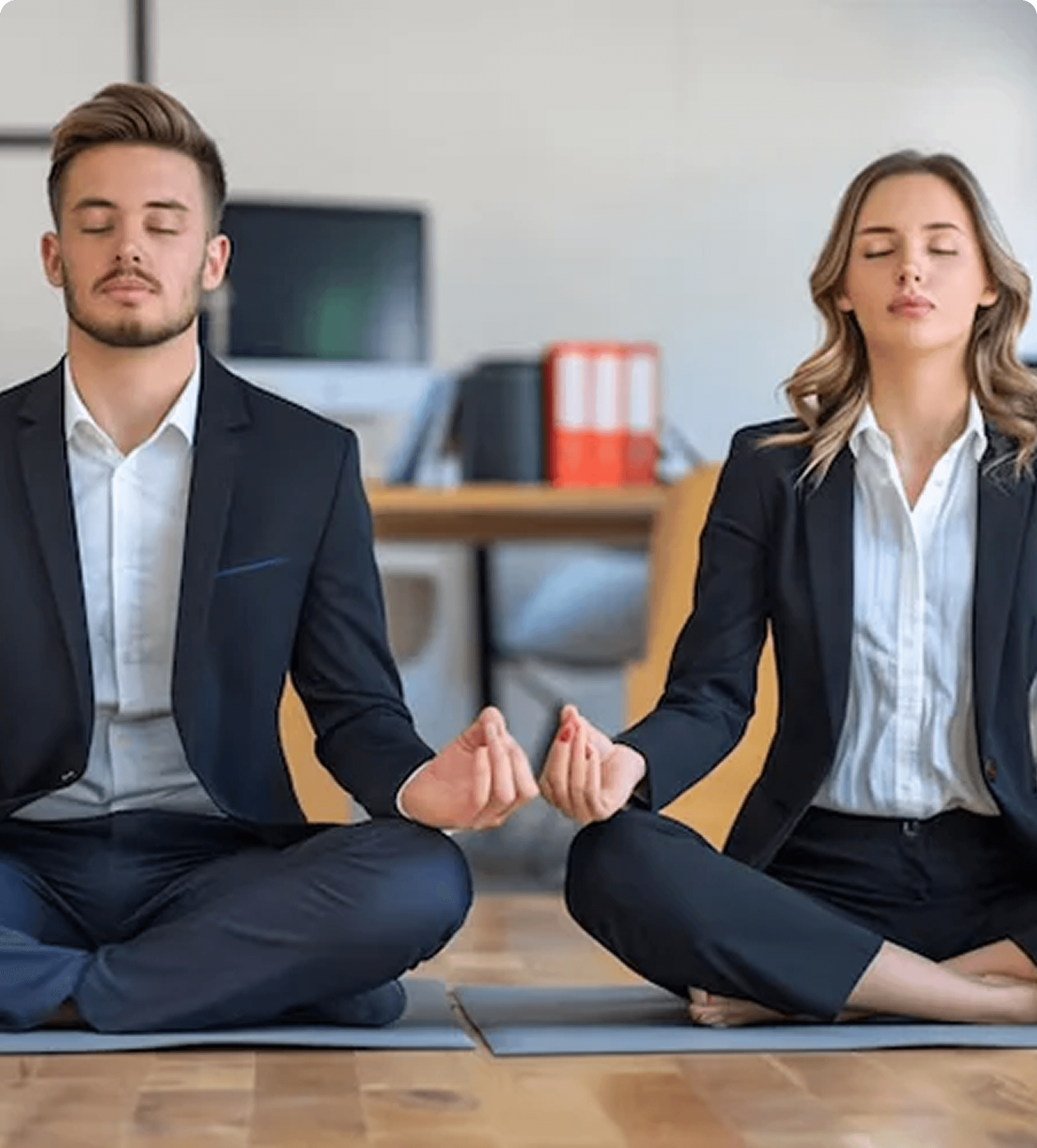 Group of people practicing mindfulness meditation in a calm, sunlit studio.